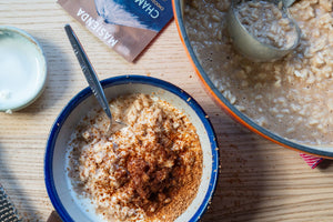 Bowl of Arroz con Leche with Champurrado garnished with champurrado mix and sweet crema
