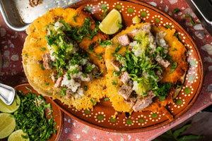 Death Bed Tacos topped with onion, cilantro, and salsa verde