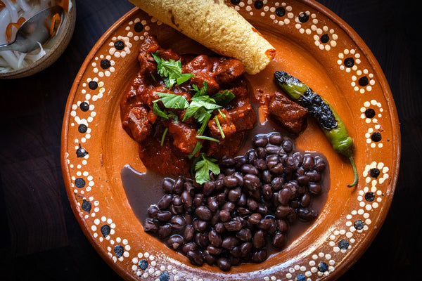 Plate with chile colorado and frijoles