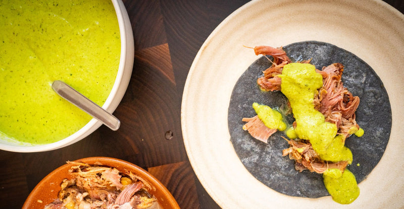 Carnitas taco topped with salsa verde