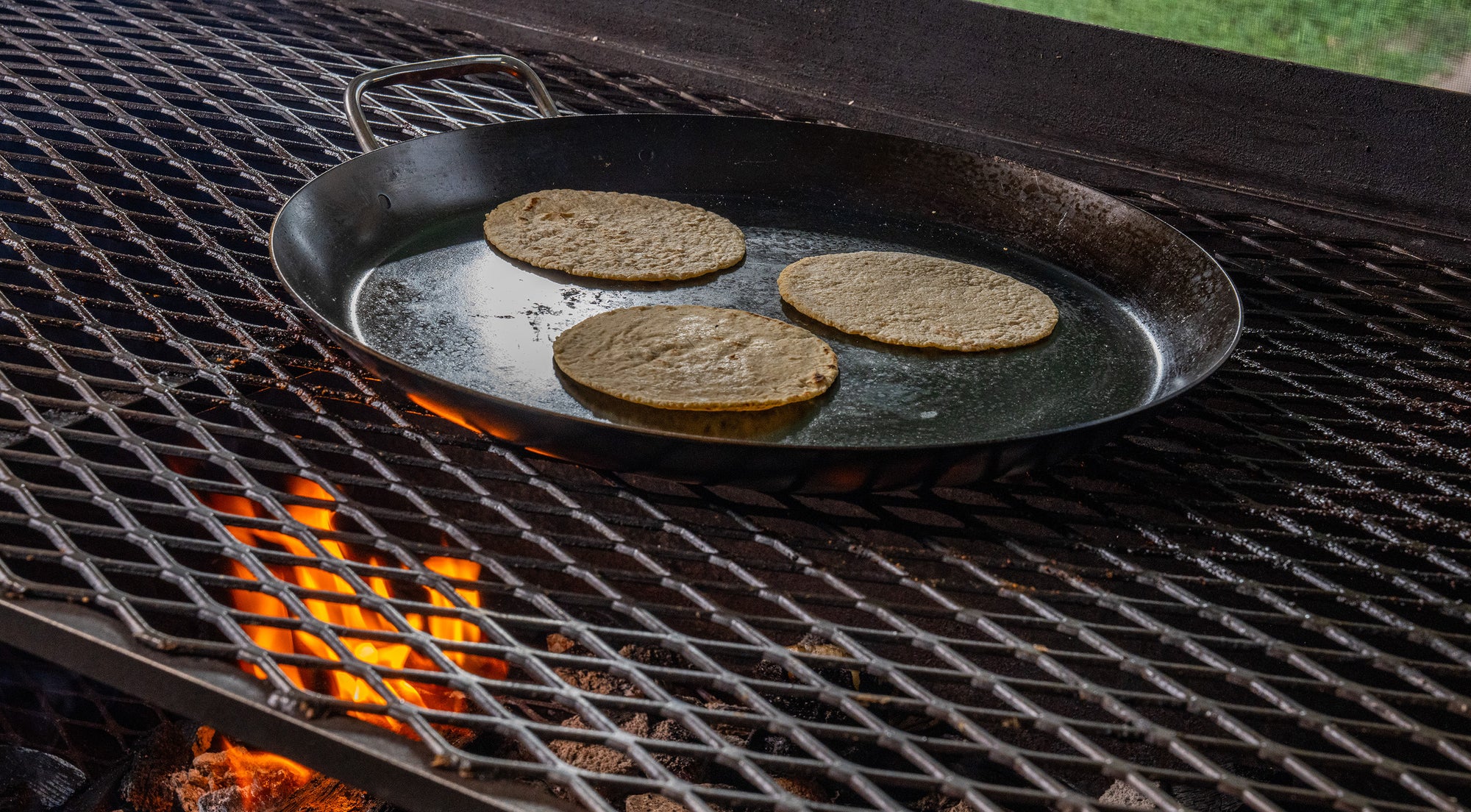 Comal with three tortillas on a grill