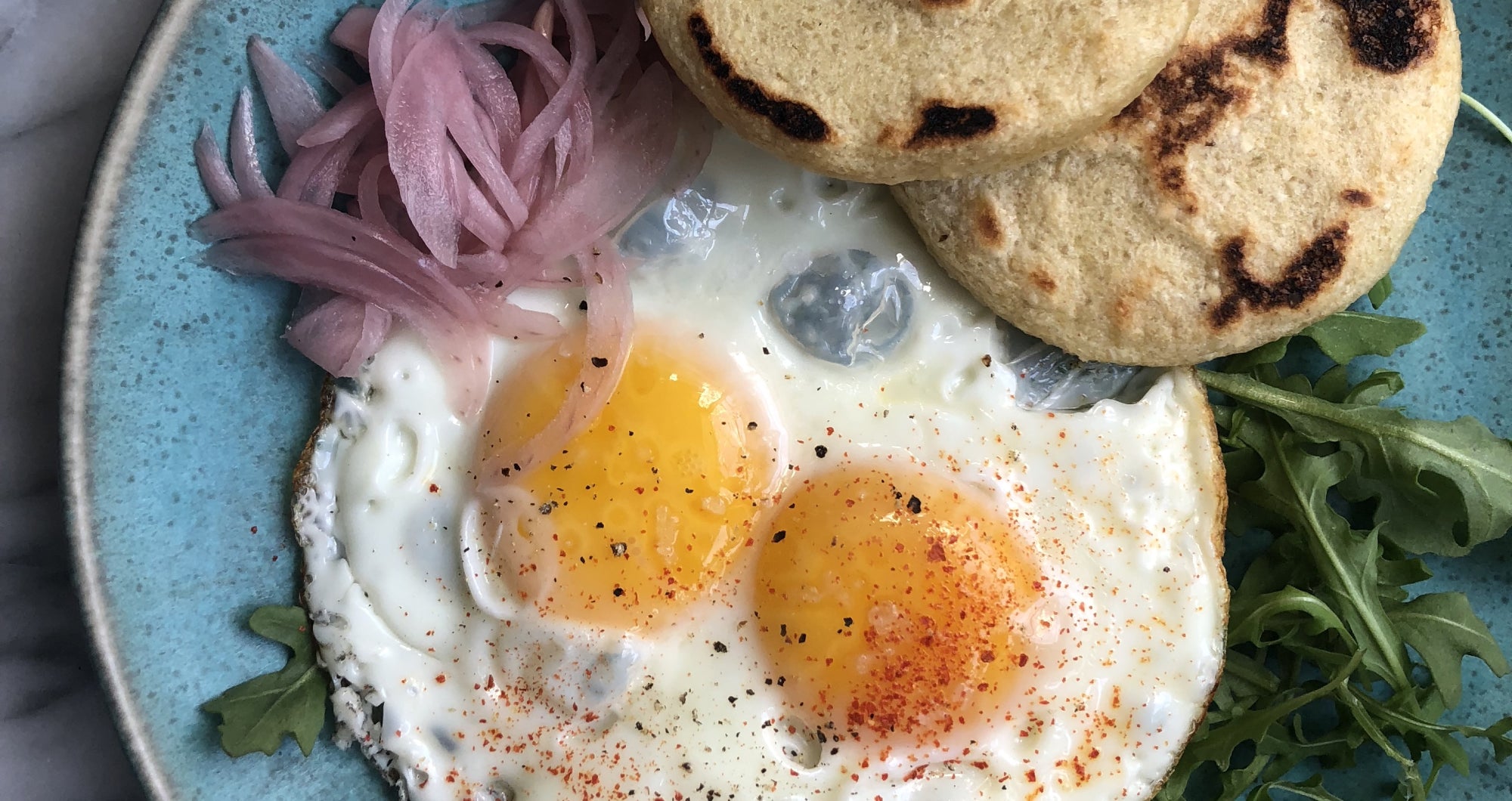 A plate with arepas and eggs