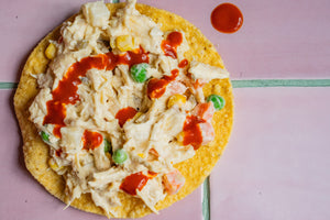 Mexican chicken salad on a tostada with valentina hot sauce