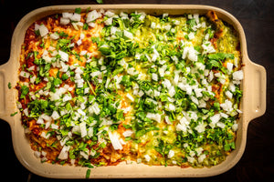 Breakfast enchiladas topped with onion and cilantro