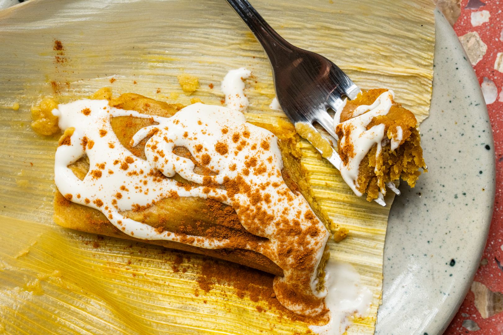 Pumpkin tamal topped with whipped cream and maple syrup