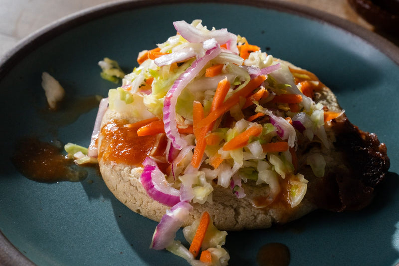 Plate of a pupusa with curtido