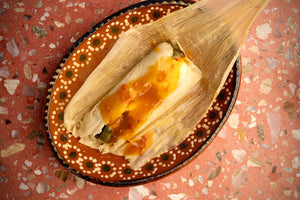 Delicious tamales de rajas con queso—soft masa filled with roasted poblano chiles and melted Oaxaca cheese.