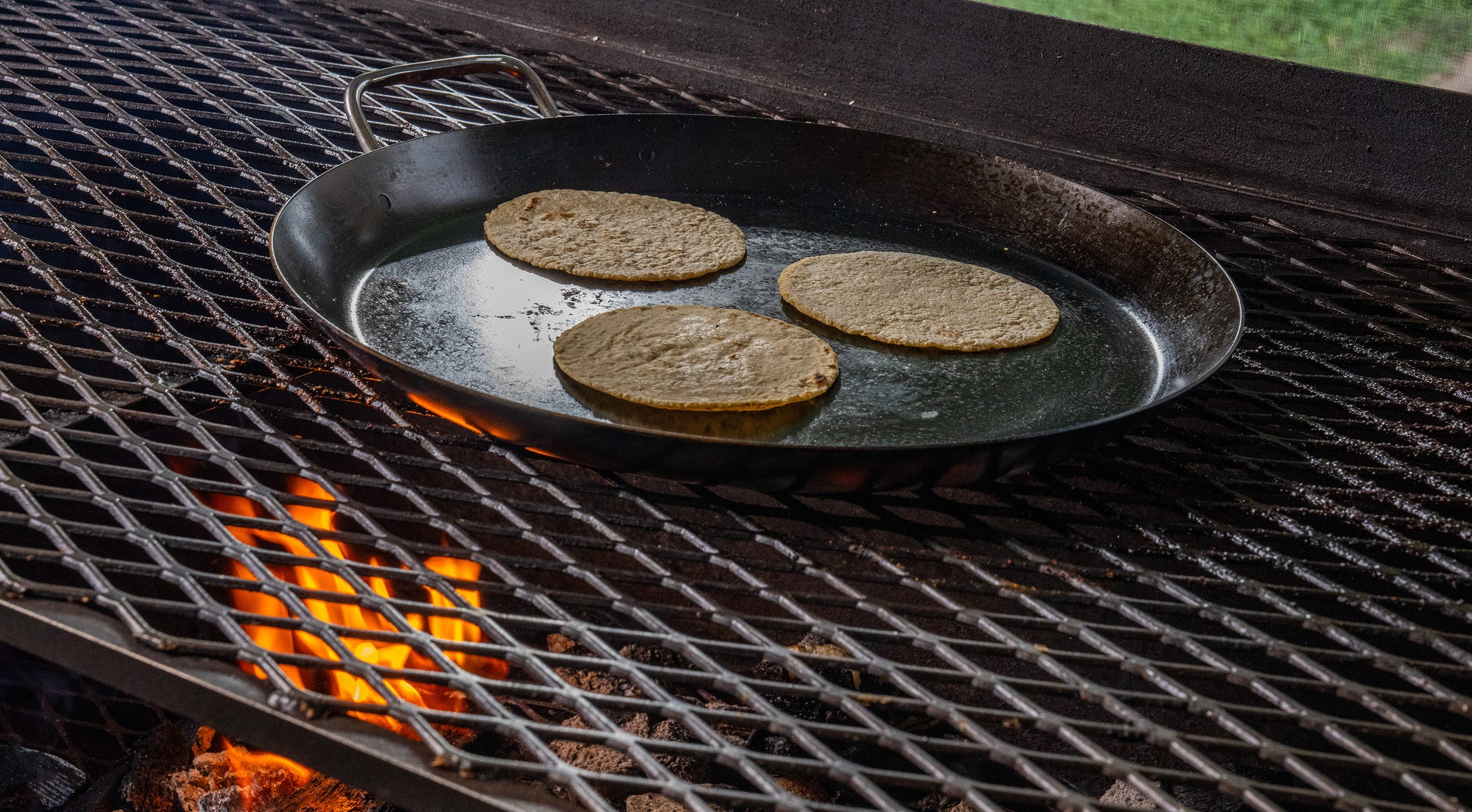 Comal with three tortillas on a grill 