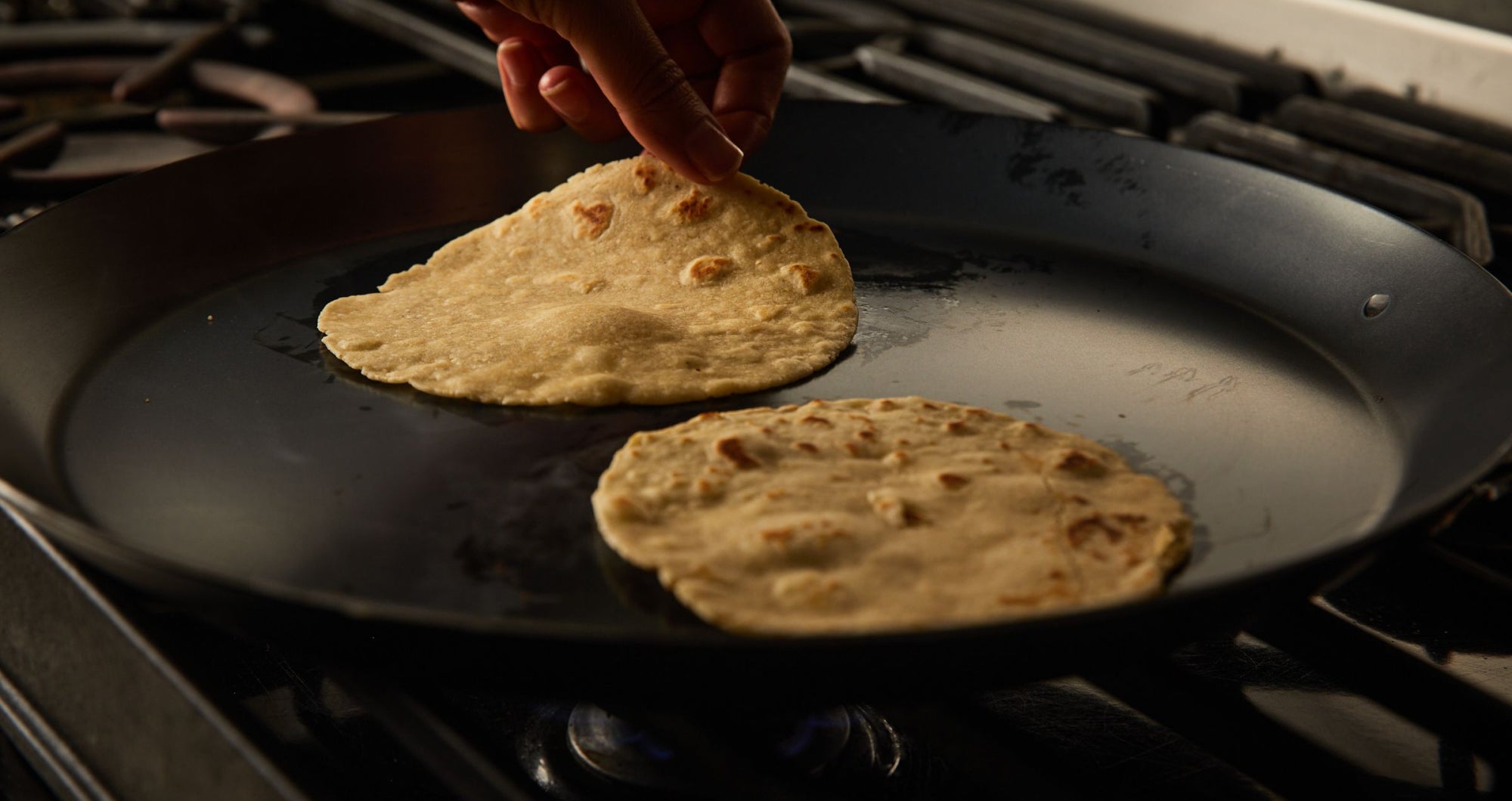 Tortillas being cooked on a comal